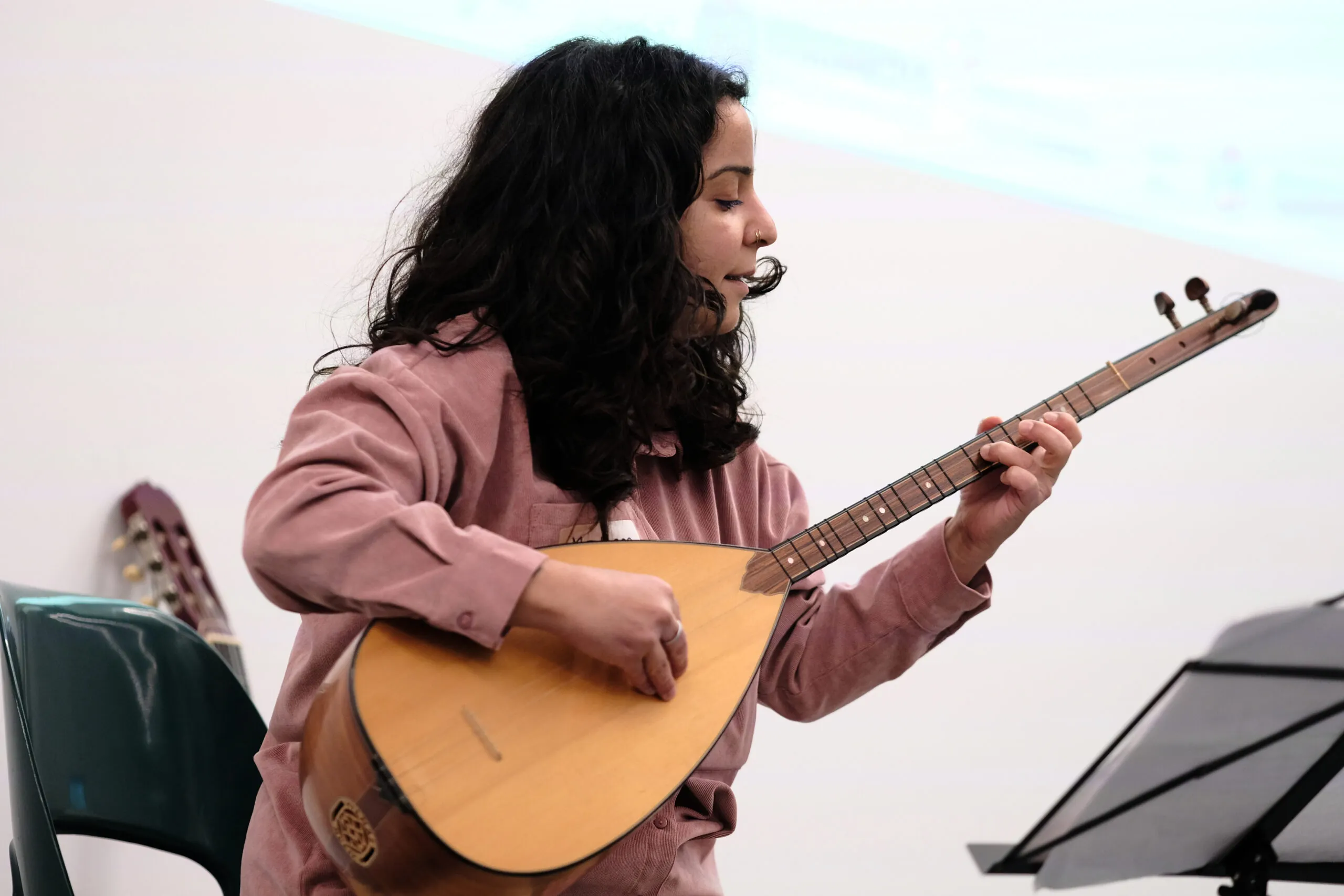 A person is playing a plucked string instrument.