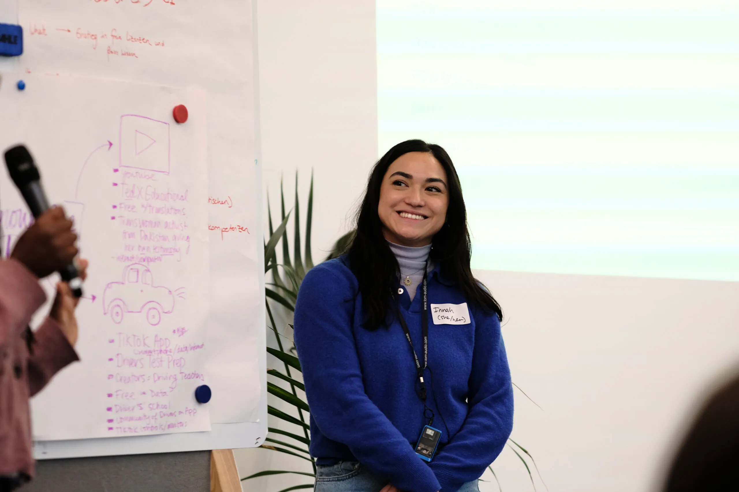 A participant in the kick-off workshop stands smiling in the picture.