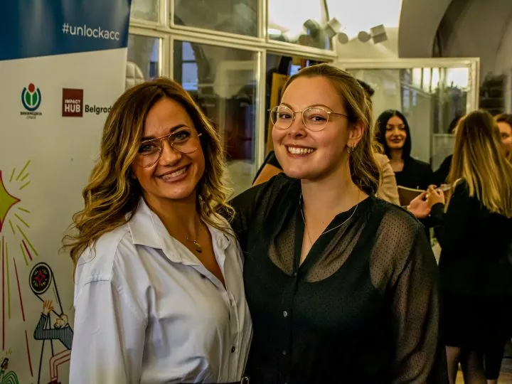 Two people smiling into the camera